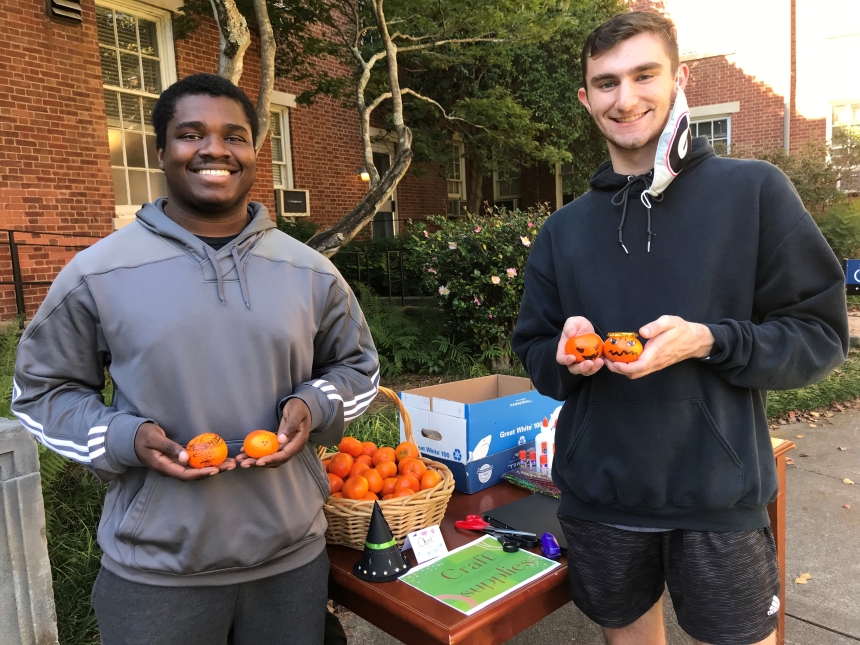 Students in the German Student Organization at the University of Georgia make tiny jack o'lanterns at the fall social event.