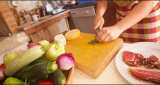 hands chopping vegetables on cutting board