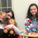 two students show off their decorations made for international coffee hour on feb. 15