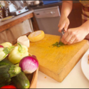 hands chopping vegetables on cutting board